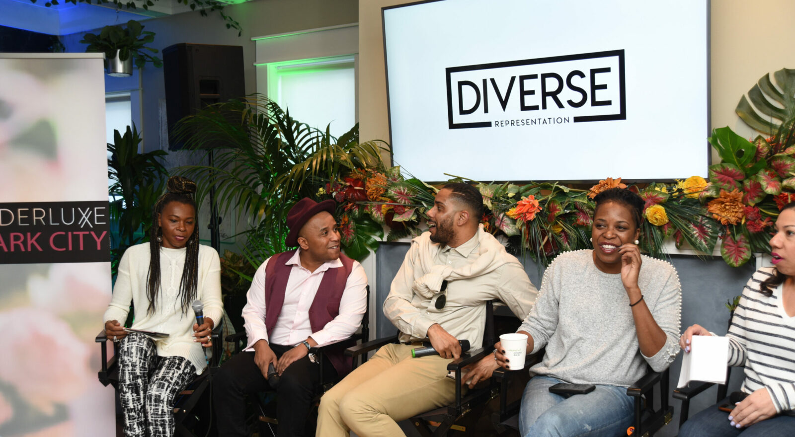 A group discussion at a diversity panel, with speakers seated and engaging with the audience.