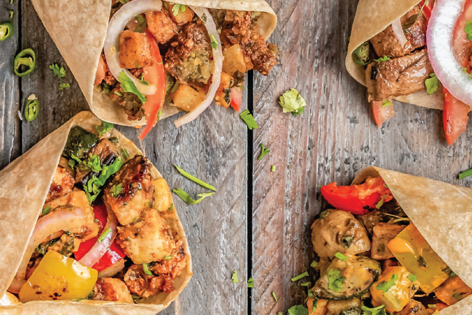 Close-up of vibrant and flavorful tacos filled with grilled chicken, fresh vegetables, and garnished with cilantro, showcasing the rich culinary traditions of Texas.